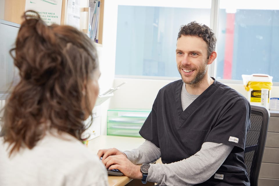 Dr Dan Epstein in consultation at his desk
